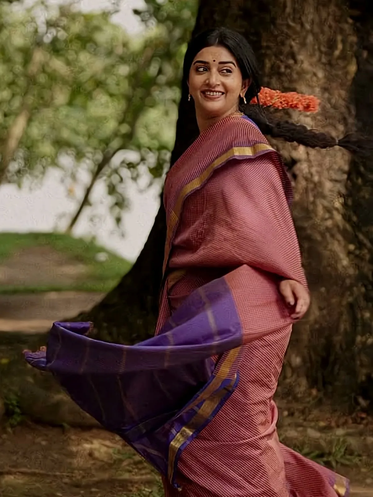 Meera Jasmine — The violet pallu caught mid-swing