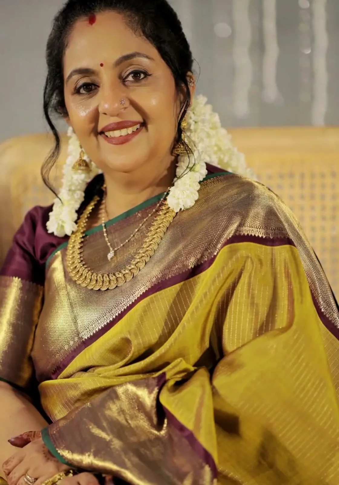 Sindhu Krishna — Seated: the zari lines in the body and the bottle-green selvedge
