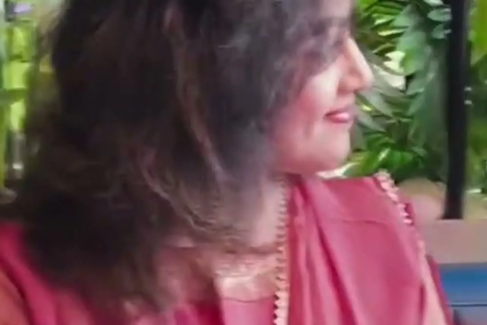 Meena — At the café, turning — the dupatta’s lace edge at the neck