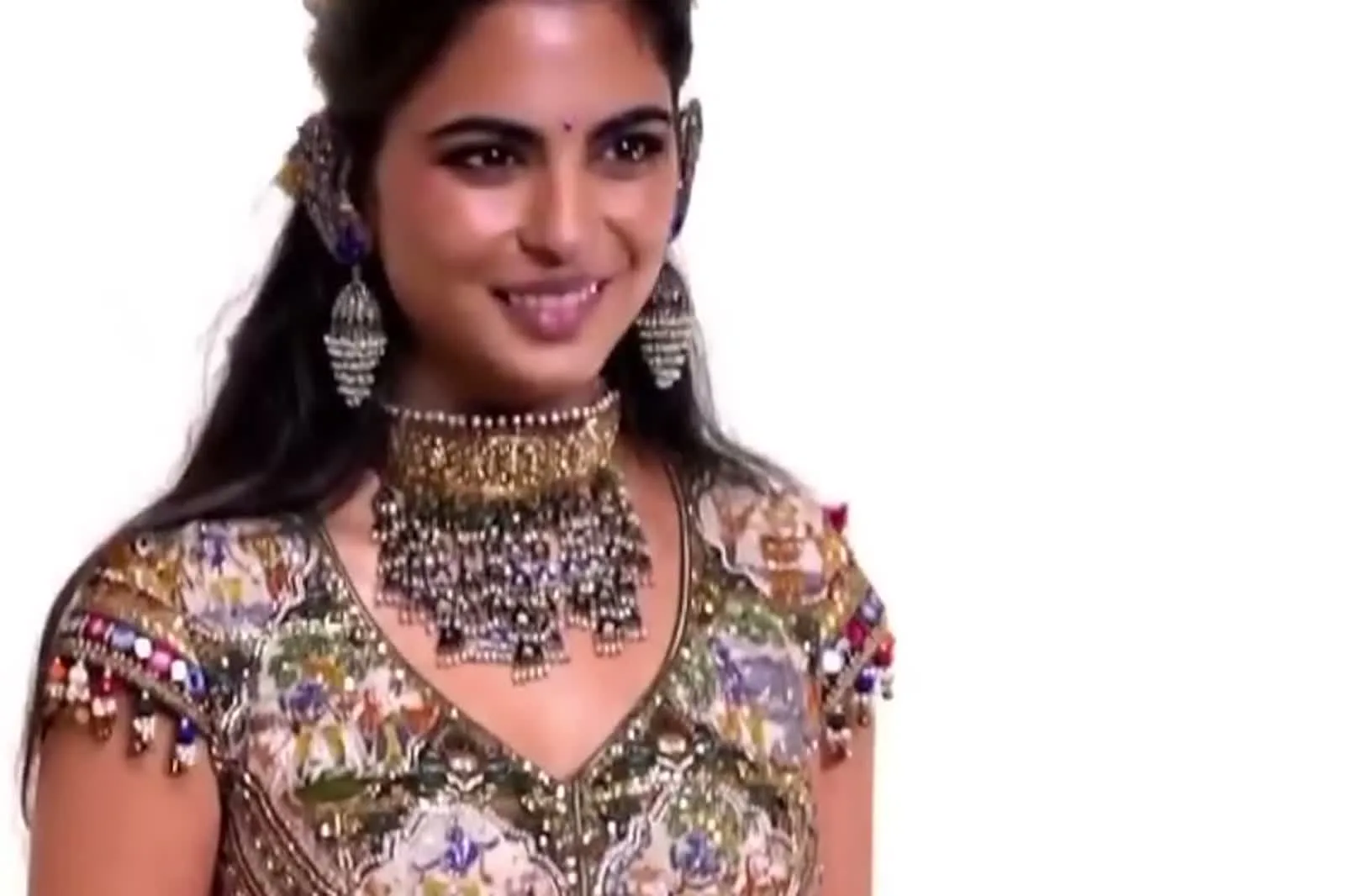 Isha Ambani — Pom-pom tassels and mirrors along the cap sleeve