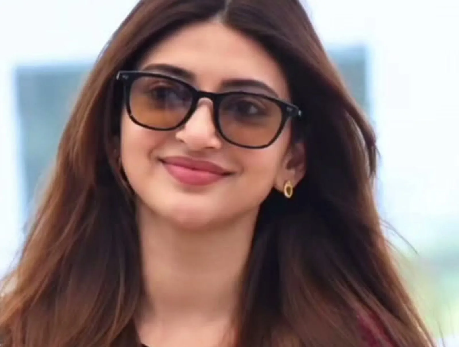Sreeleela — The sunglasses: a black square frame with brown gradient lenses