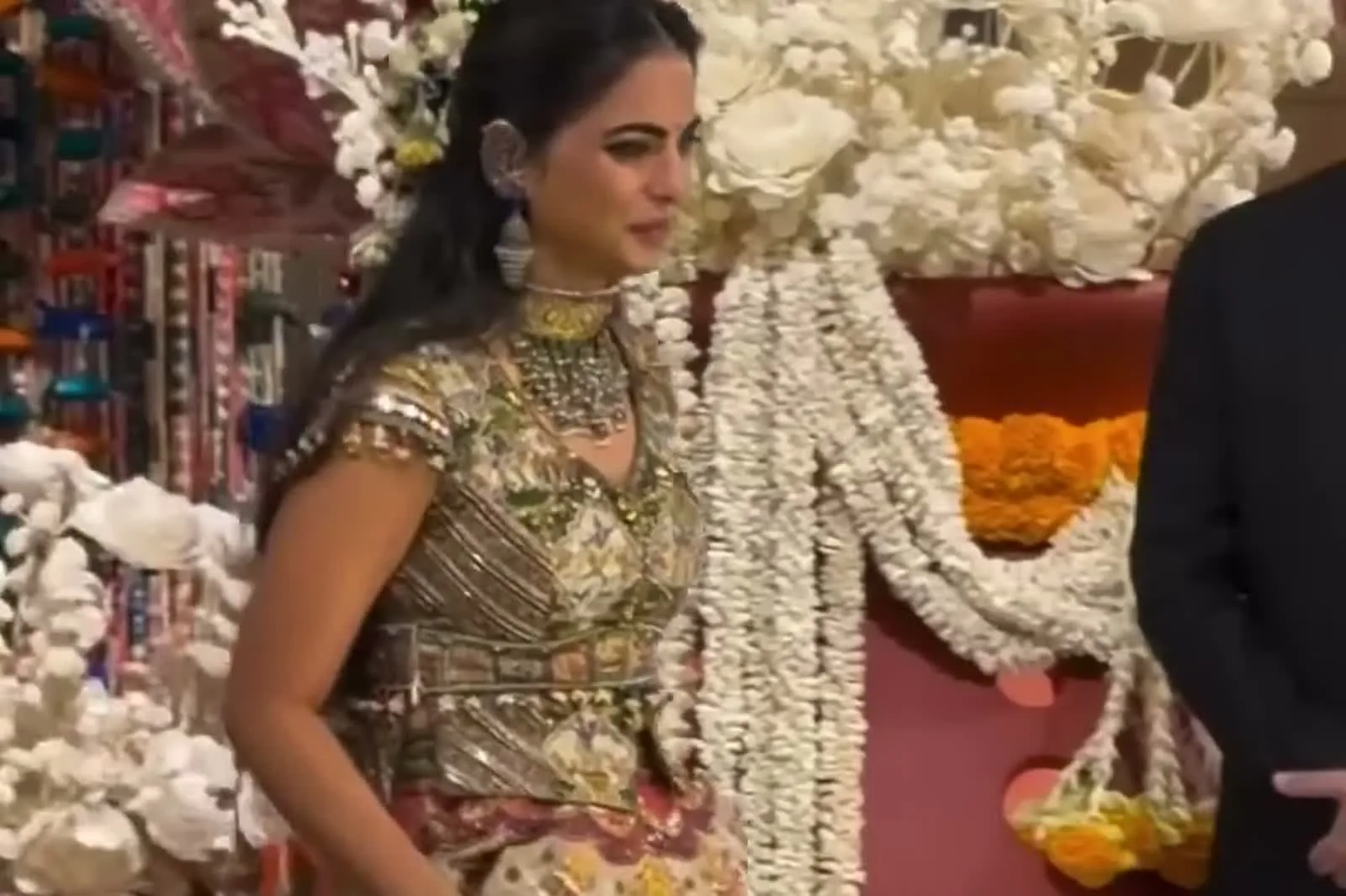 Isha Ambani — Arriving past the jasmine garlands