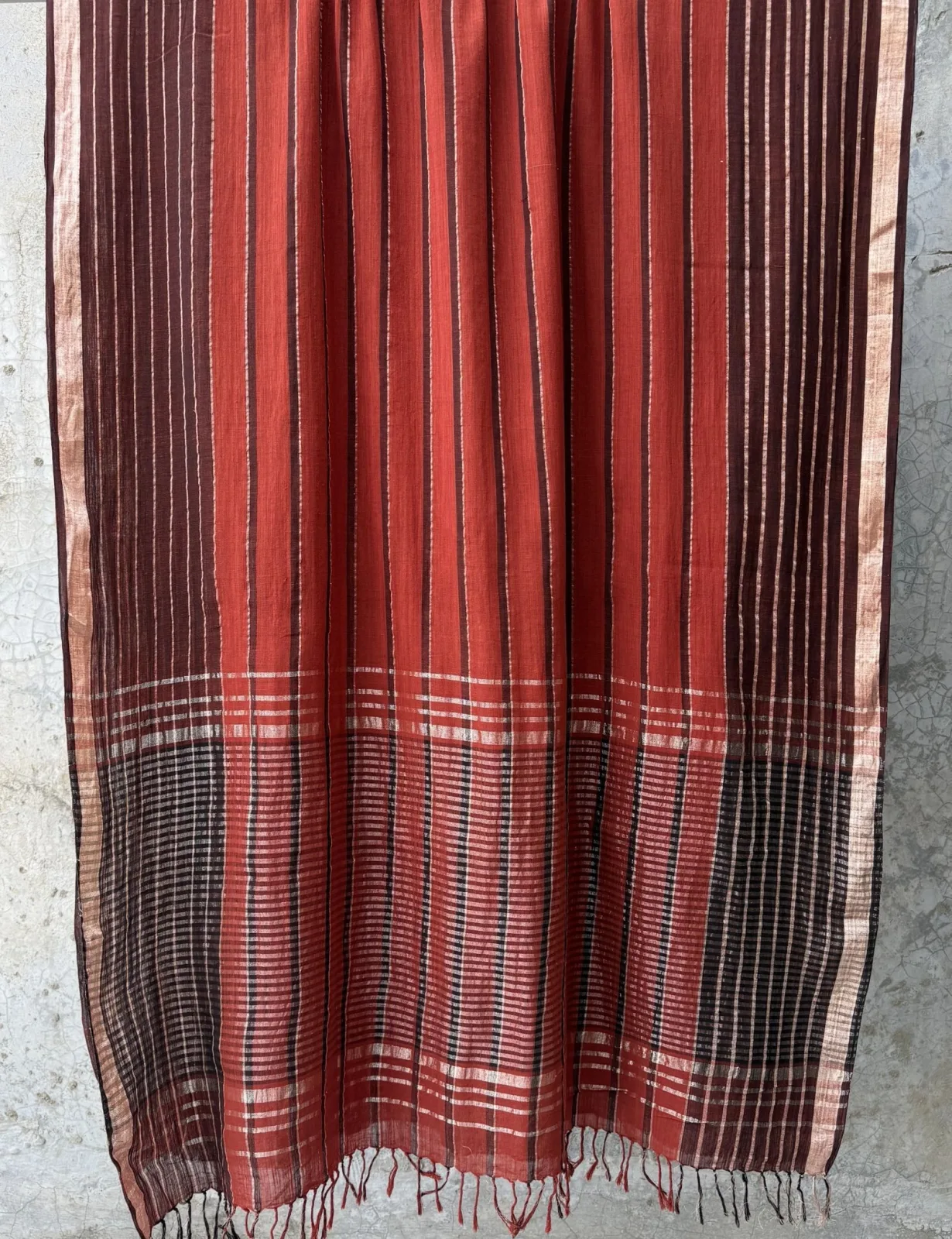 Taanbaan Rust saree with indigo stripe band and gold-striped border